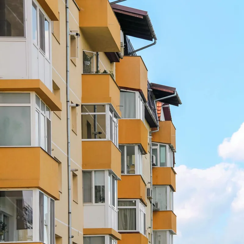Modern apartment building exterior showing shared roofing requiring body corporate management
