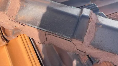 Close-up of cracked and deteriorated roof pointing on a Perth home