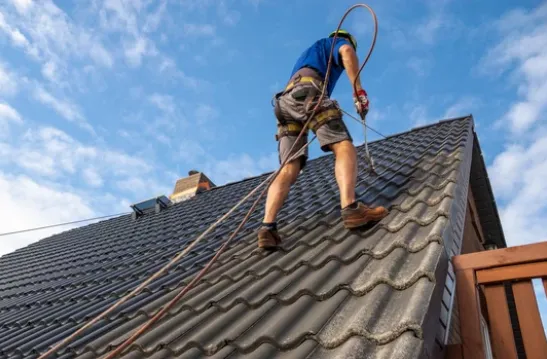 Roof restoration work being carried out on a steep pitched roof