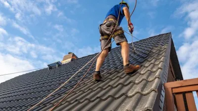 Roof restoration work being carried out on a steep pitched roof