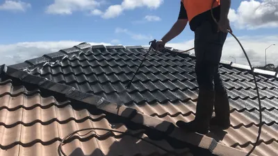 Roof being painted during a professional restoration in Perth