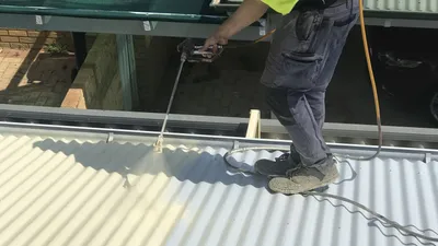 Spraying a fresh coat during a Perth roof restoration